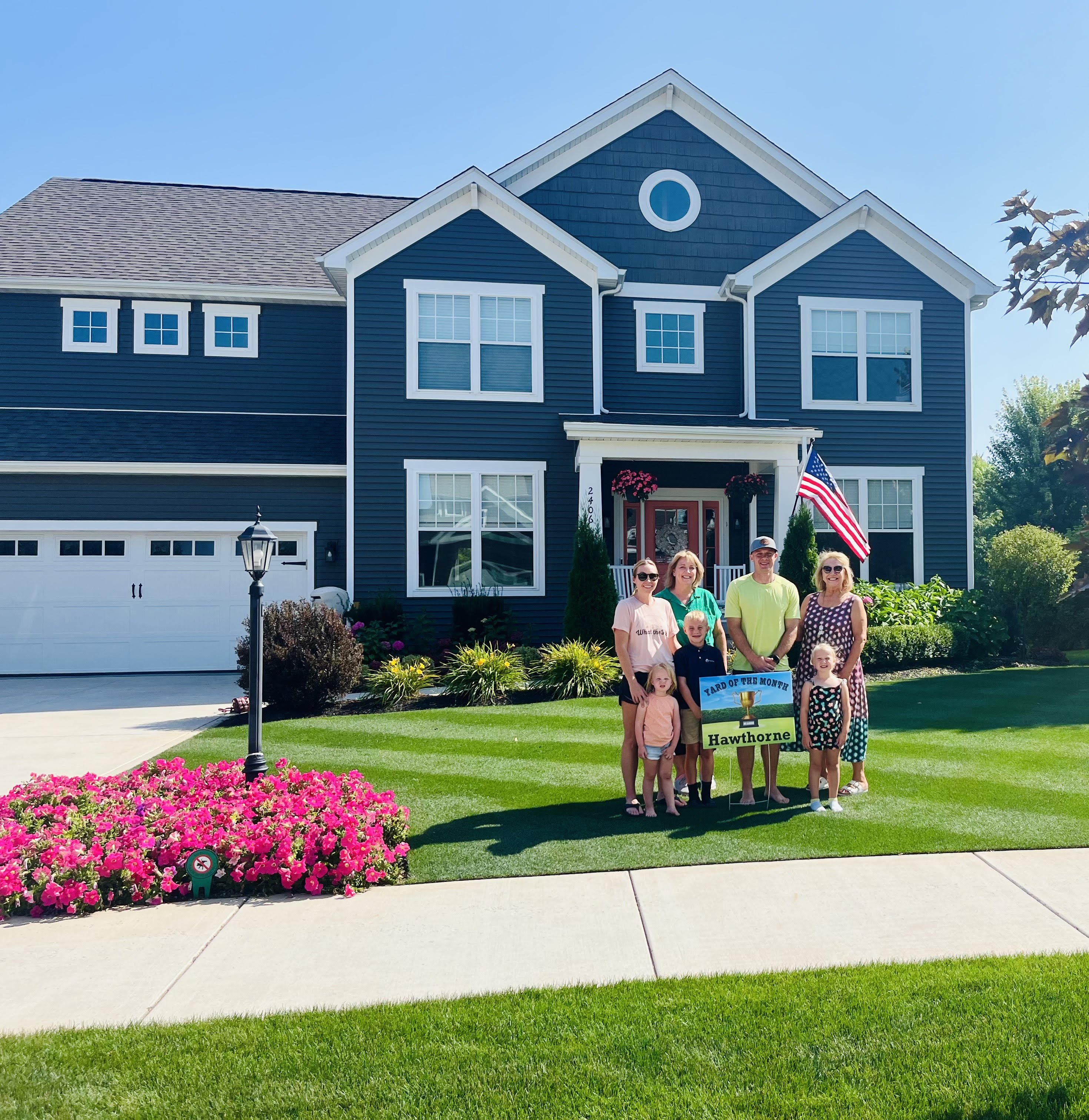 Photo a family in front of a single family home at 2406 Nottingham, Valparaiso, Indiana, 46383.