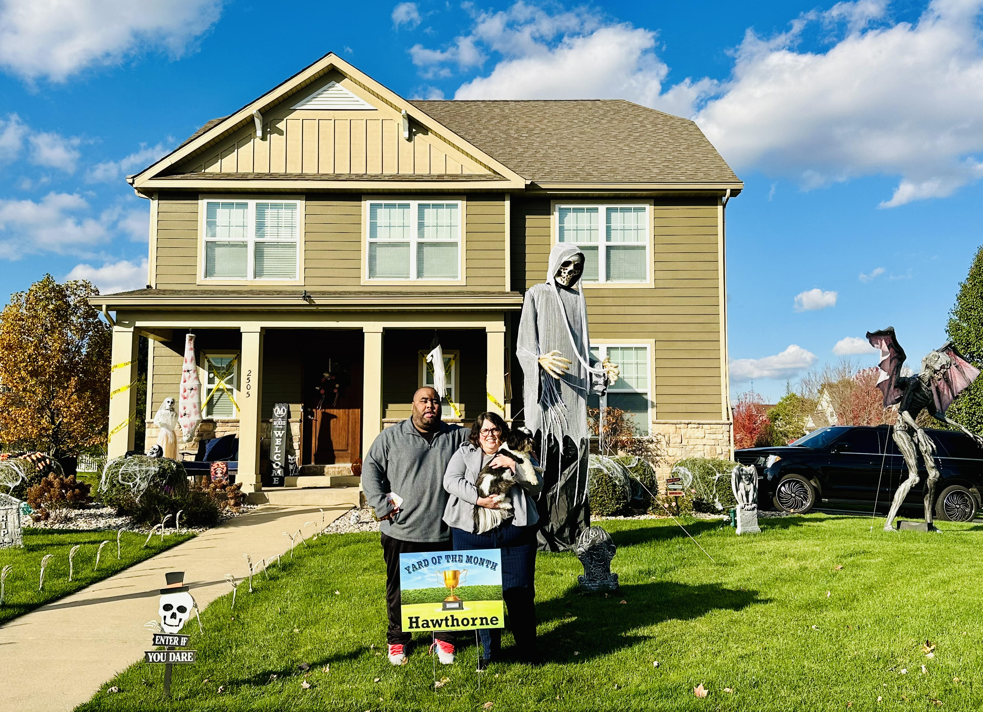 Photo of homeowners and a 12 foot tall skeleton at a single family home at 2505 Nottingham, Valparaiso, Indiana, 46383.