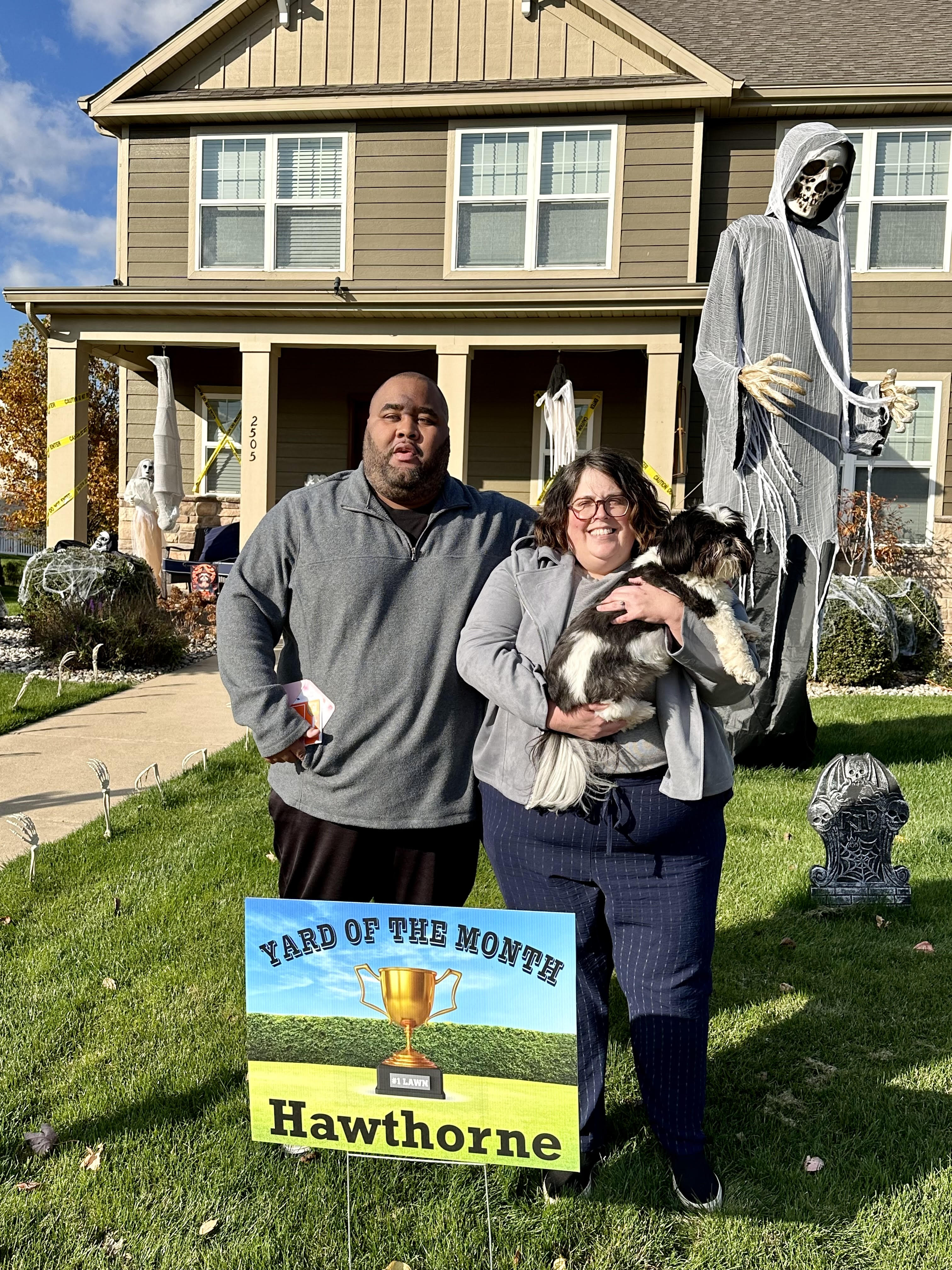 Closeup photo of homeowners and a 12 foot tall skeleton at a single family home at 2505 Nottingham, Valparaiso, Indiana, 46383.