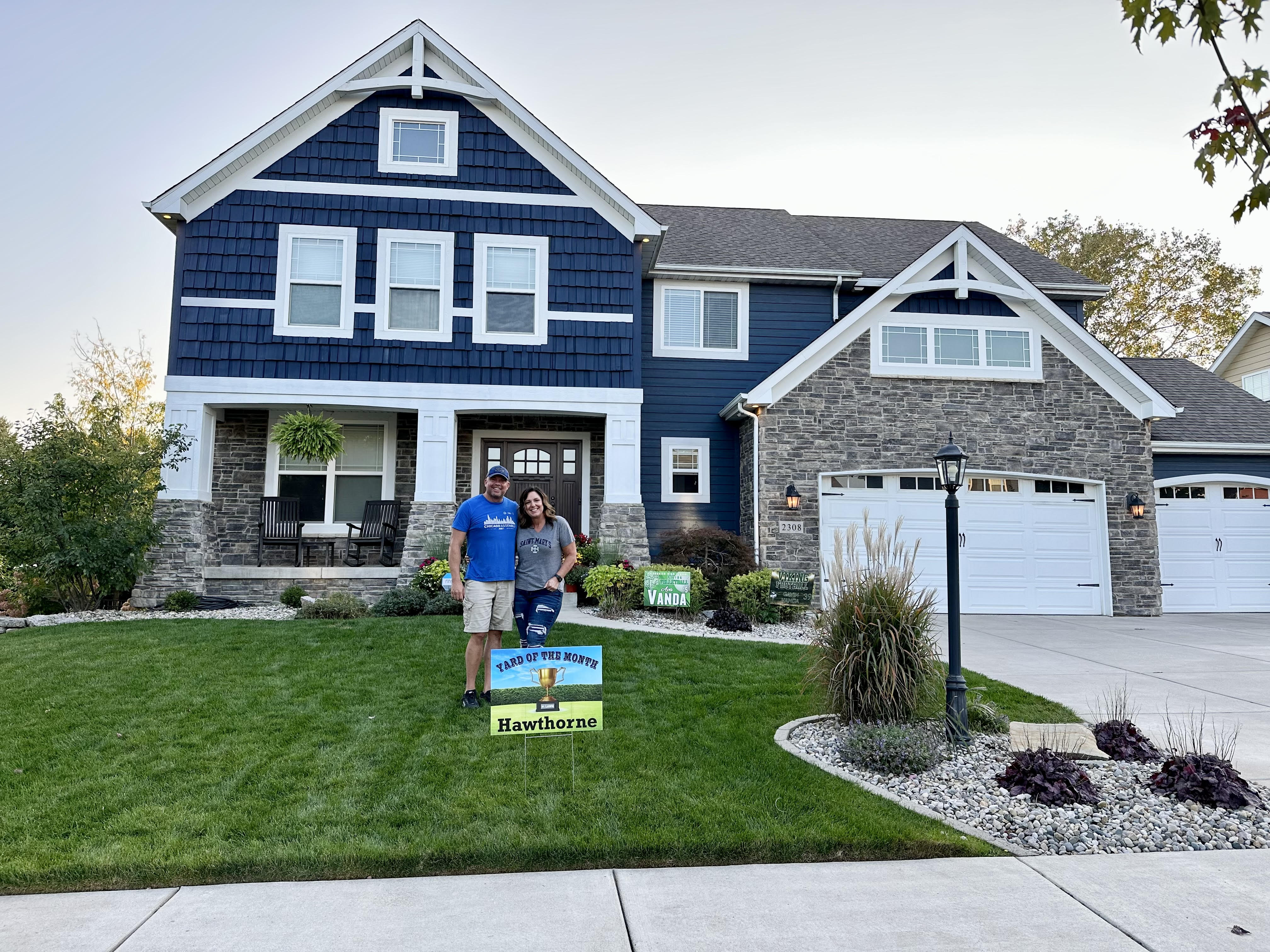 Photo of homeowners and a yard sign in front of a single family home at 2308 Nottingham, Valparaiso, Indiana, 46383.