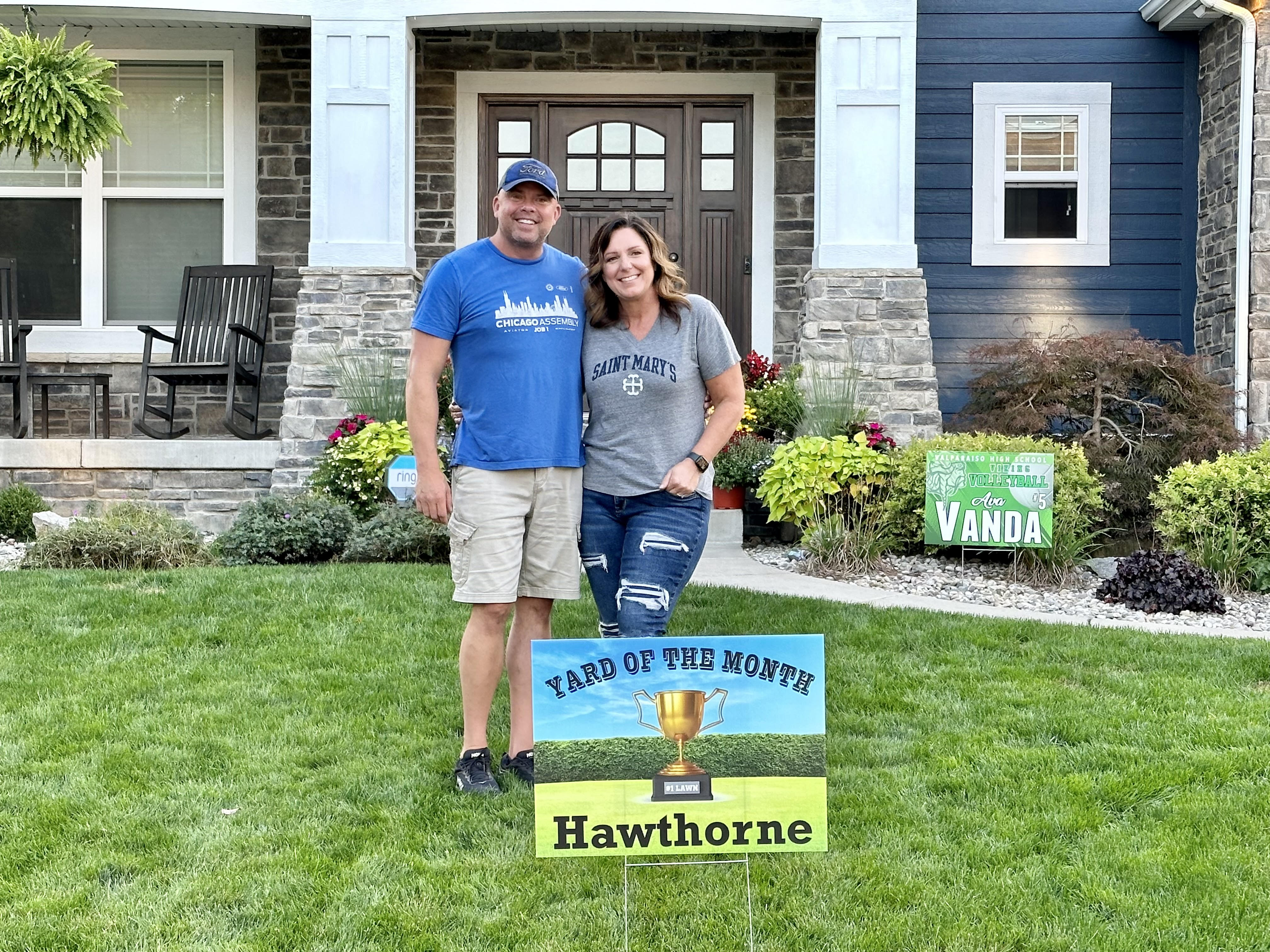 Another closeup photo of homeowners and a yard sign in front of a single family home at 2308 Nottingham, Valparaiso, Indiana, 46383.